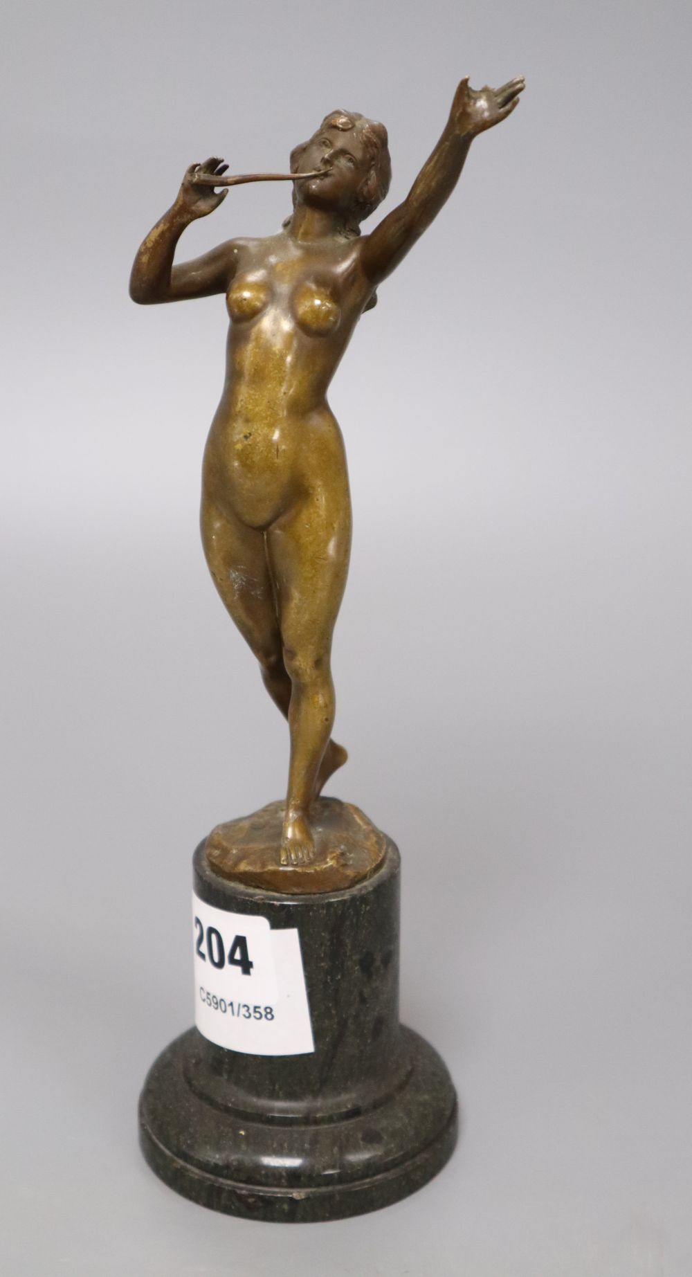 An early 20th century bronze of a nude lady, indistinctly signed, on marble base, overall height 25cm